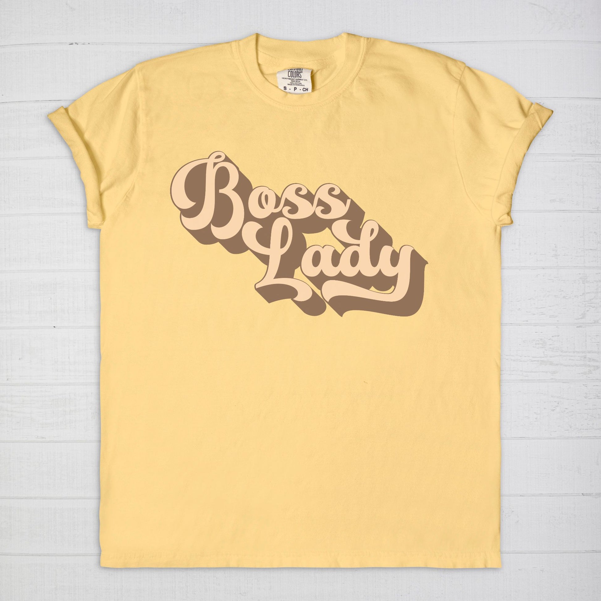 Embrace vintage vibes with the Comfort Color Tee 1717 - Boss Lady Retro from Designs On The Go. This comfy, durable tee boasts a chic, nostalgic design perfect for making a statement. Whether you’re at work or out with friends, this tee combines style and comfort seamlessly.