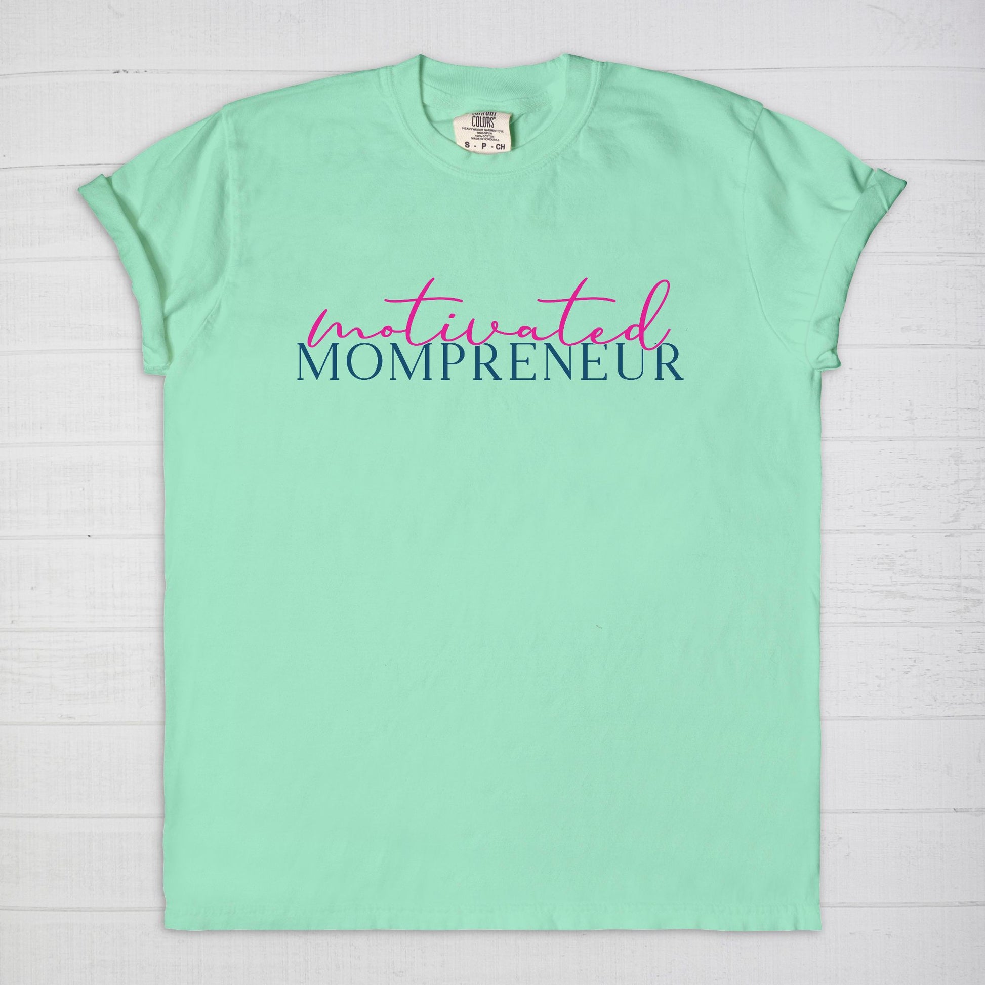 Elevate your entrepreneurial style with the Comfort Color Tee 1717 - Motivated Mompreneur from Designs On The Go. This premium tee offers unmatched comfort and durability, perfect for driven moms balancing business and family. Wear your motivation proudly and inspire others every day!