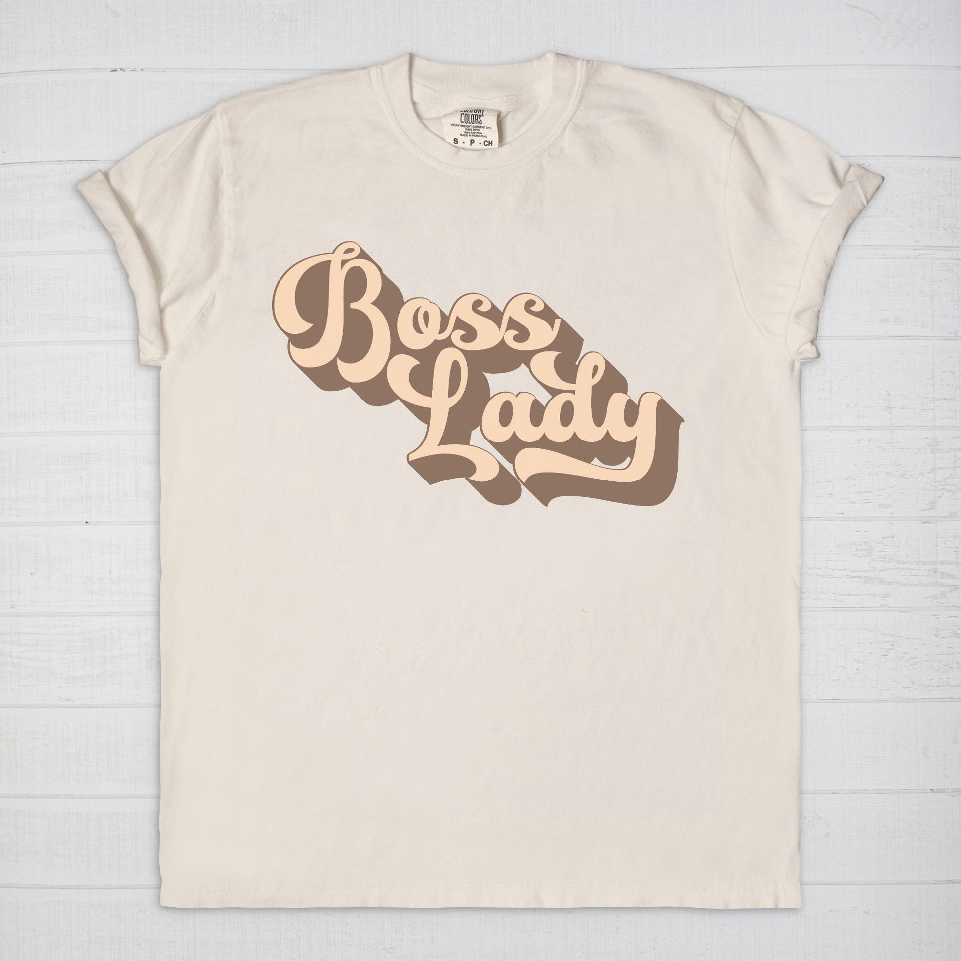 Embrace vintage vibes with the Comfort Color Tee 1717 - Boss Lady Retro from Designs On The Go. This comfy, durable tee boasts a chic, nostalgic design perfect for making a statement. Whether you’re at work or out with friends, this tee combines style and comfort seamlessly.