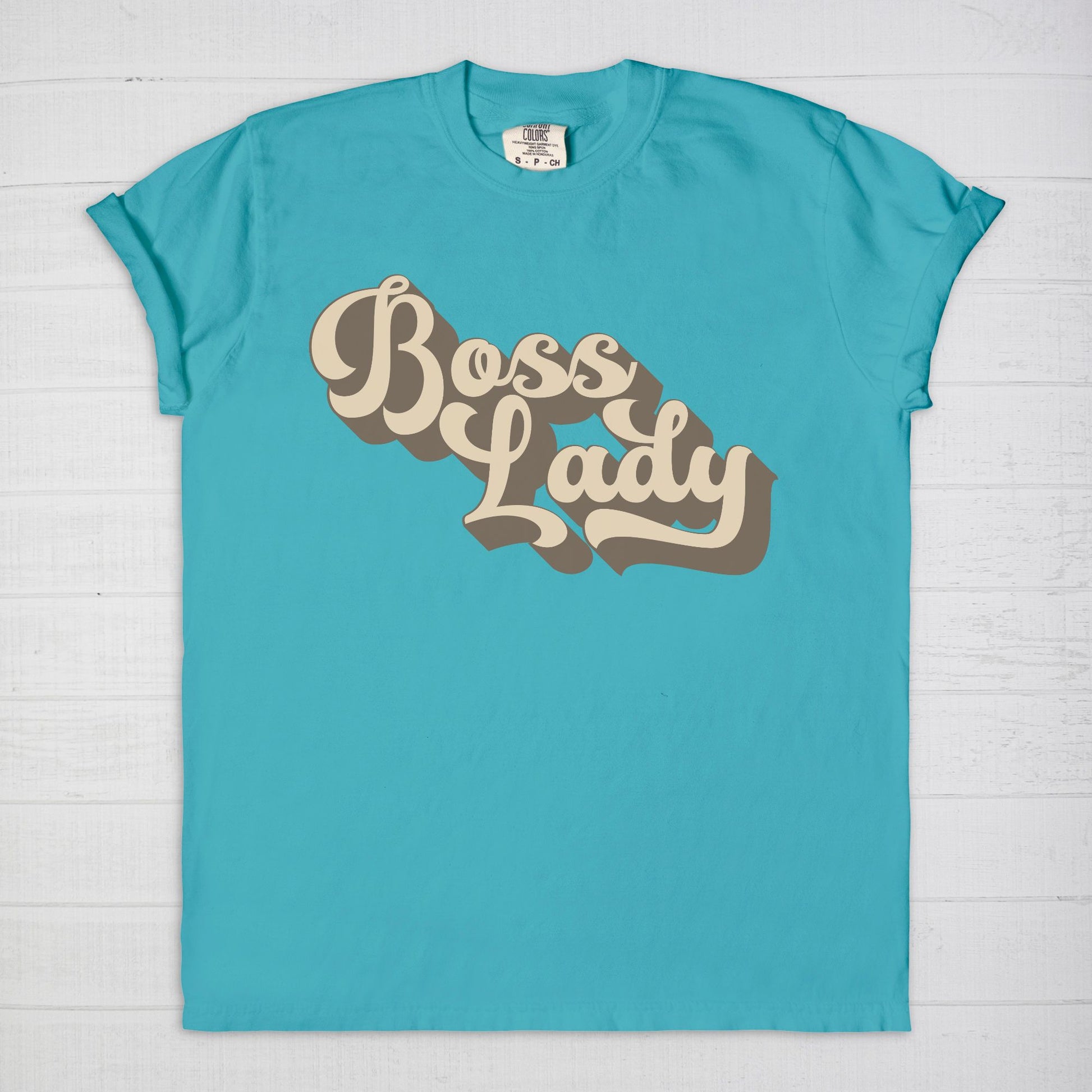 Embrace vintage vibes with the Comfort Color Tee 1717 - Boss Lady Retro from Designs On The Go. This comfy, durable tee boasts a chic, nostalgic design perfect for making a statement. Whether you’re at work or out with friends, this tee combines style and comfort seamlessly.