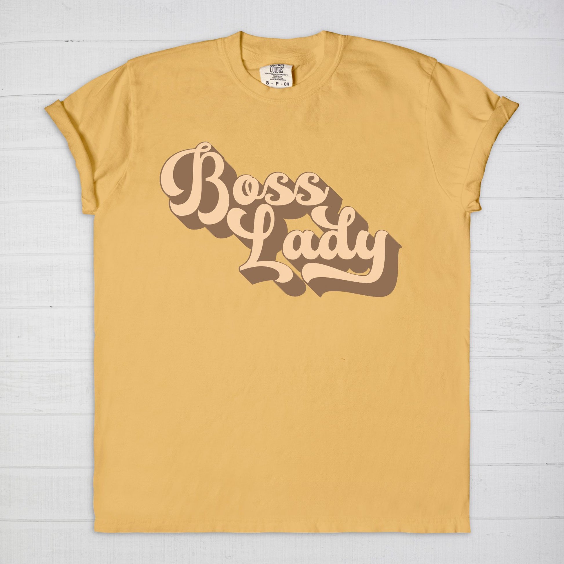 Embrace vintage vibes with the Comfort Color Tee 1717 - Boss Lady Retro from Designs On The Go. This comfy, durable tee boasts a chic, nostalgic design perfect for making a statement. Whether you’re at work or out with friends, this tee combines style and comfort seamlessly.