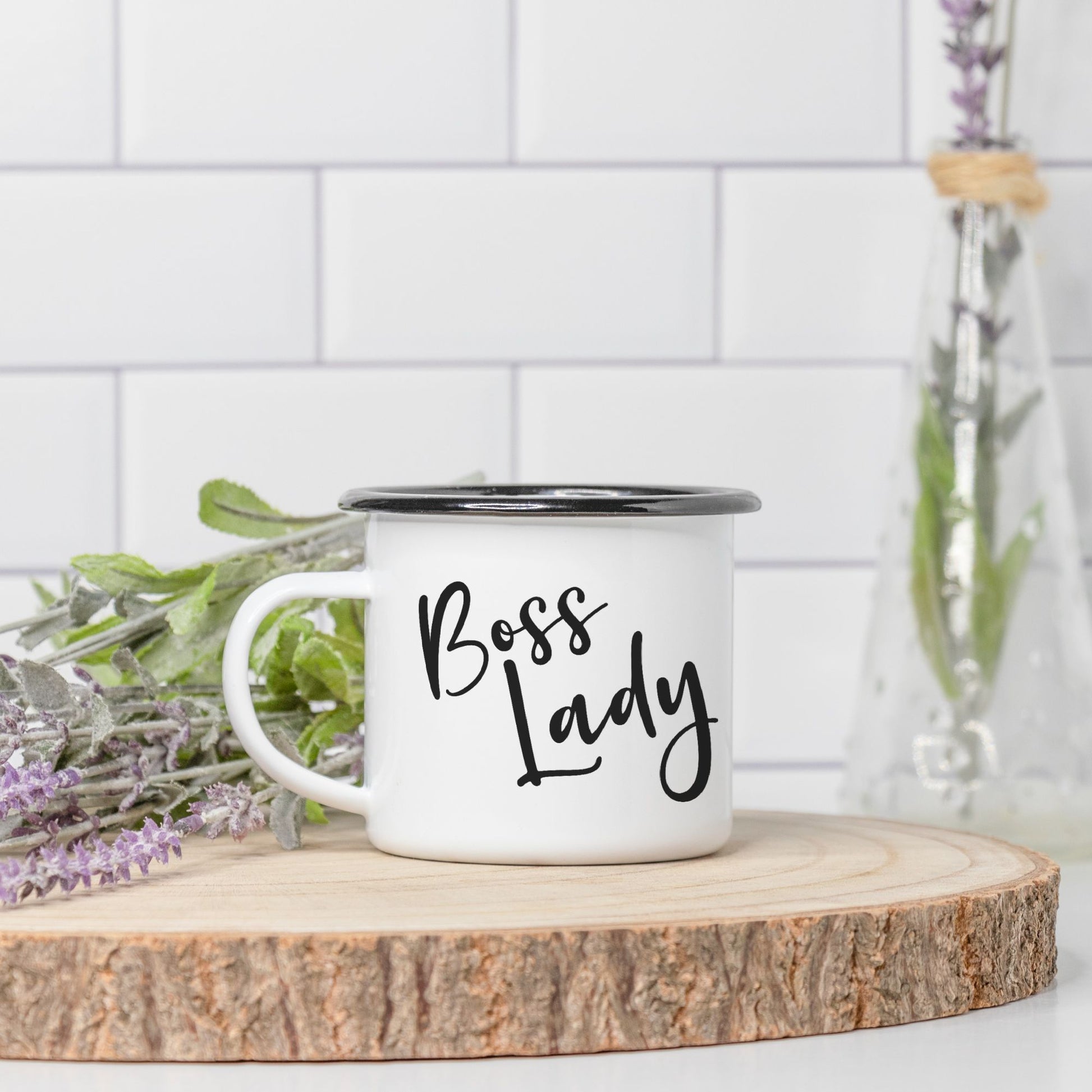 Sip in style with our Camp Mug 10 oz. (Black Rim) - Boss Lady from Designs On The Go. Add a touch of empowerment to your morning routine with this durable and stylish mug, perfect for coffee or tea lovers on the go.