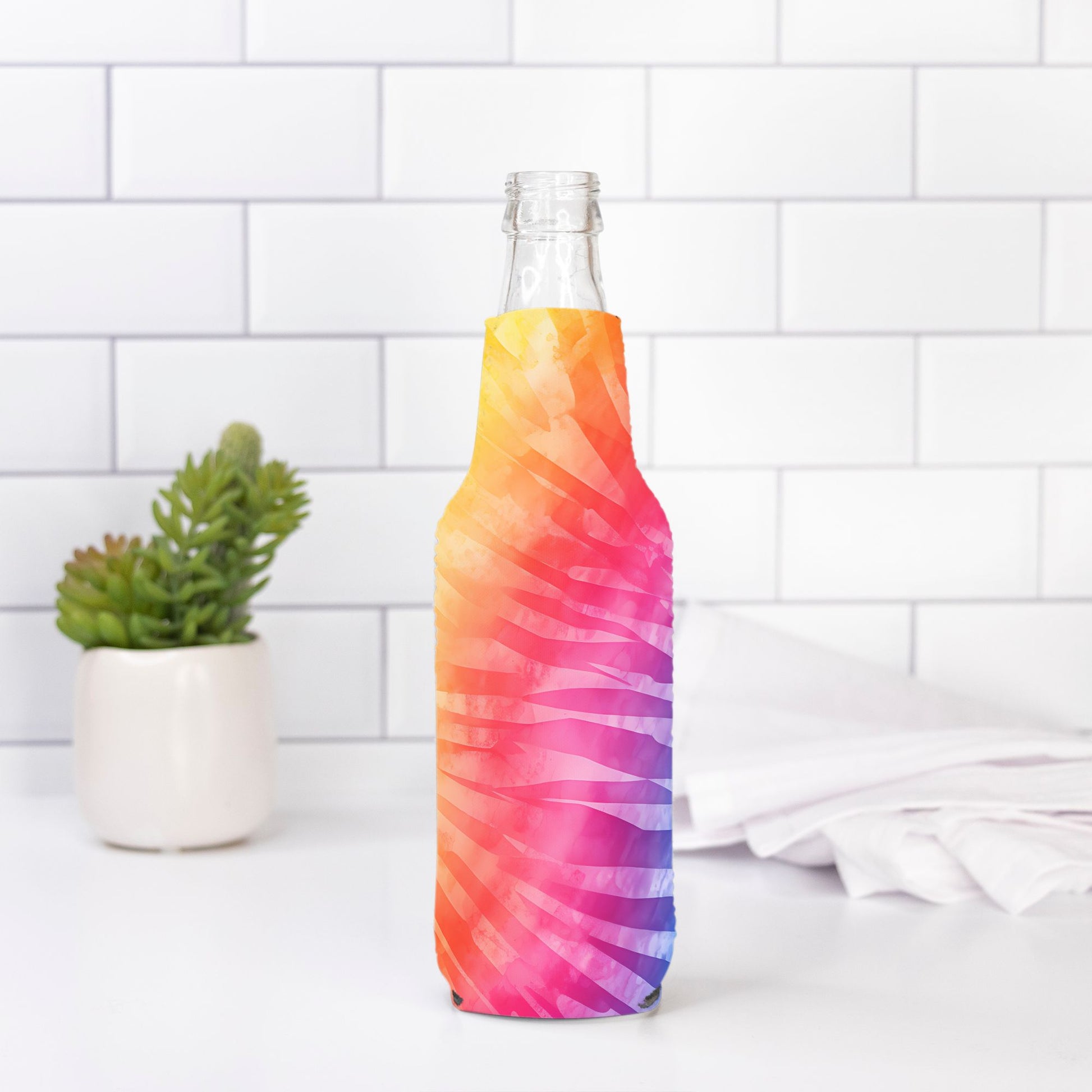 Add a splash of color to your bottle with our Bottle Wrap - Rainbow Tie Dye from Designs On The Go. Featuring a vibrant tie-dye pattern, this durable wrap transforms your hydration routine with a fun, eye-catching design. Perfect for expressing your unique style, it's an ideal accessory for any bottle.