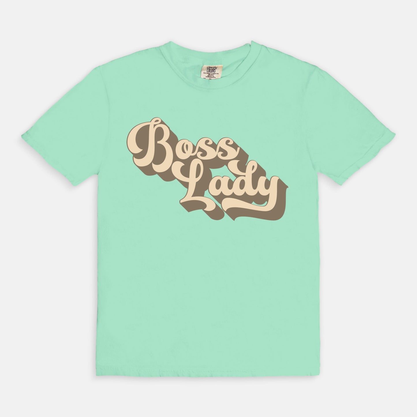 Embrace vintage vibes with the Comfort Color Tee 1717 - Boss Lady Retro from Designs On The Go. This comfy, durable tee boasts a chic, nostalgic design perfect for making a statement. Whether you’re at work or out with friends, this tee combines style and comfort seamlessly.